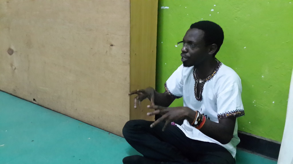 Jason Ntaro gives feedback to another poet